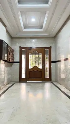 an empty room with a large wooden door and windows at SUITOUISS - Agdal 1 - Appartement à 2 minutes de la gare de train TGV Rabat in Rabat