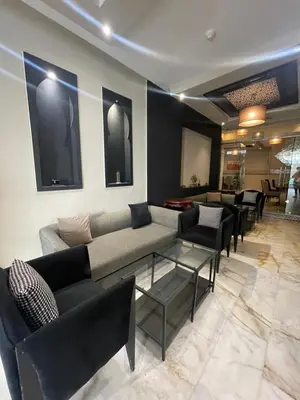 a living room with a couch and chairs at Cadé Hotel in Casablanca