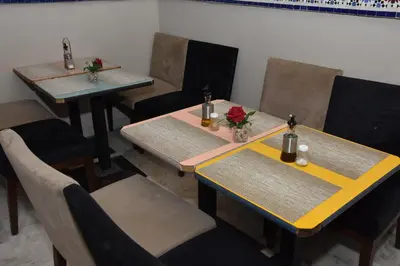 three tables in a restaurant with flowers on them at Cadé Hotel in Casablanca