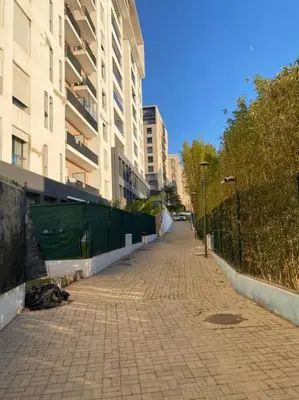 an empty sidewalk in a city with buildings at Studio à Prestigia HayRiad/Rabat in Rabat