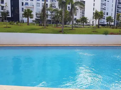 a large blue swimming pool in a city at Studio à Prestigia HayRiad/Rabat in Rabat