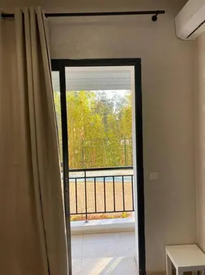 an open door to a balcony with a window at Studio à Prestigia HayRiad/Rabat in Rabat
