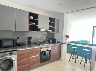a kitchen with a stove and a washing machine at Appartement CFC - Aeria mall in Casablanca