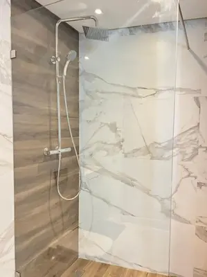 a shower with a glass door in a bathroom at Appartement CFC - Aeria mall in Casablanca