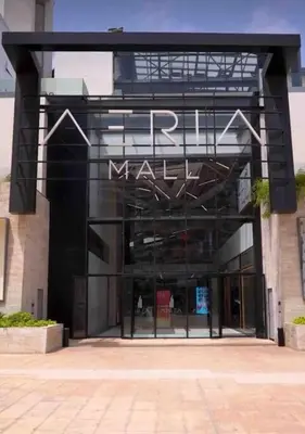 a mall building with a sign on the front of it at Appartement CFC - Aeria mall in Casablanca