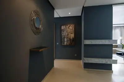 a hallway with blue walls and a mirror on the wall at Beautifully Designed 3BR Apartment+ Panoramic View in Rabat