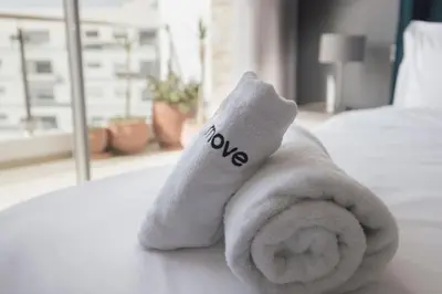 a towel with the word no written on it on a bed at Beautifully Designed 3BR Apartment+ Panoramic View in Rabat