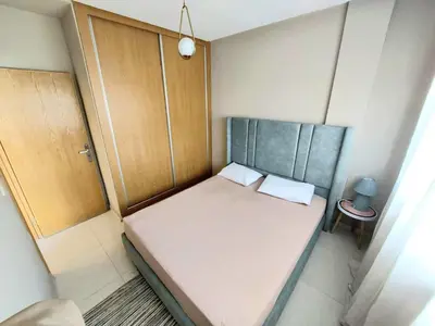 a small bed in a small room with a small table at top apartment Airport Mohamed 5 in Derroua