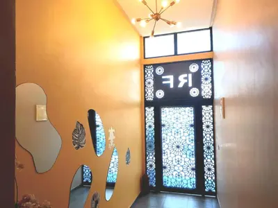 a room with a door with a window and butterflies at top apartment Airport Mohamed 5 in Derroua