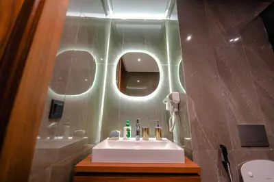 a bathroom with a white sink and a mirror at ROYAL ANFA PARK SUITE-BY AYLA STAY in Casablanca