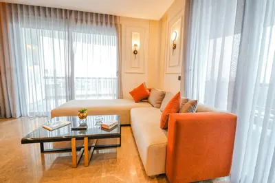 a living room with a couch and a table at ROYAL ANFA PARK SUITE-BY AYLA STAY in Casablanca