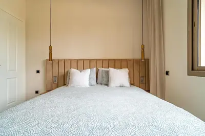 a bedroom with a large bed with white pillows at AeroSuite in Nouaceur