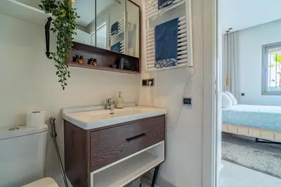 a bathroom with a sink and a mirror at AeroSuite in Nouaceur