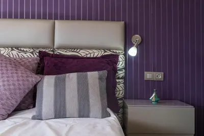 a bedroom with a bed with a purple wall at Luxury villa Bouskoura Pearl in Casablanca