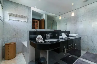 a bathroom with a sink and a mirror at Luxury villa Bouskoura Pearl in Casablanca
