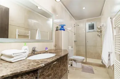 a bathroom with a sink and a toilet and a mirror at Luxury villa Bouskoura Pearl in Casablanca