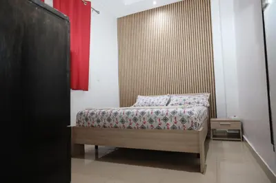 a bedroom with a bed and a red curtain at Agdal 1 in Rabat