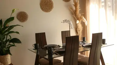 a dining room with a glass table and chairs at Maarif , Cosy 2 Chambres, Parking wifi Netflix Gratuit in Casablanca