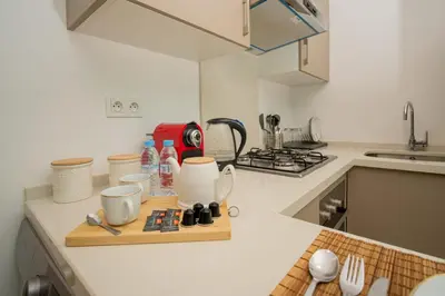 a kitchen counter with a cutting board and utensils on it at studio Maarif à 3min à pied du stade med V in Casablanca