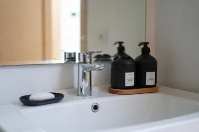 a bathroom sink with two bottles of soap and a mirror at studio Maarif à 3min à pied du stade med V in Casablanca