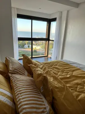 a bed in a bedroom with a large window at Luxury Villa Jack Beach Resort Ocean Oasis View Panoramic in Casablanca