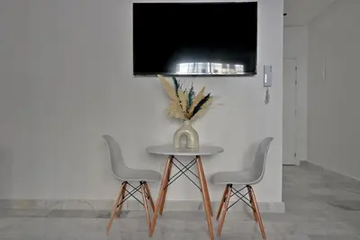 a table with three chairs and a vase on it at AeroHarmony in Nouaceur