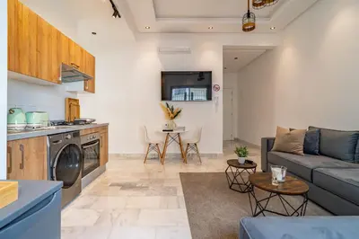 a living room with a couch and a table at AeroHarmony in Nouaceur