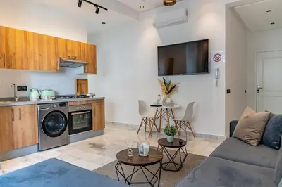 a living room with a couch and a kitchen at AeroHarmony in Nouaceur