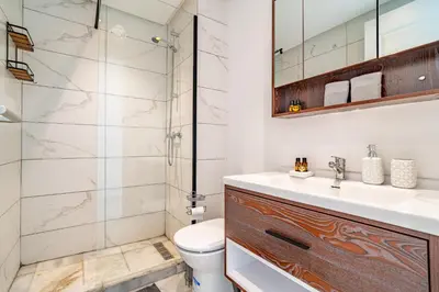 a bathroom with a shower and a toilet and a sink at AeroHarmony in Nouaceur