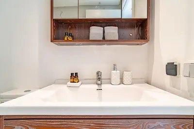 a bathroom with a white sink and a mirror at AeroHarmony in Nouaceur