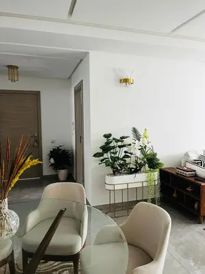 a living room with two chairs and a glass table at Harhoura Modern Flat in Temara