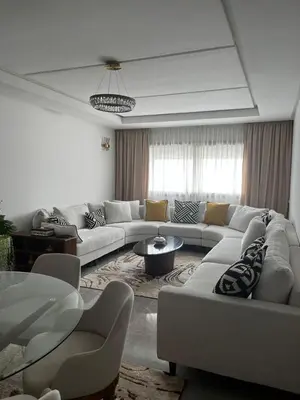 a living room with white couches and a table at Harhoura Modern Flat in Temara