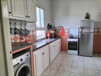 a kitchen with a refrigerator and a dishwasher at Villa Pierrette Casablanca in Casablanca