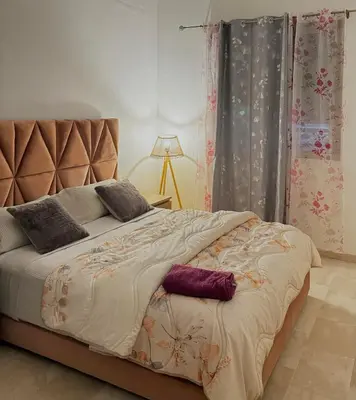 a bed with two pillows on it in a bedroom at Take a cosy rest Near the airport in Nouaceur