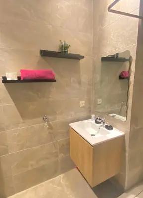 a bathroom with a sink and a mirror at Take a cosy rest Near the airport in Nouaceur