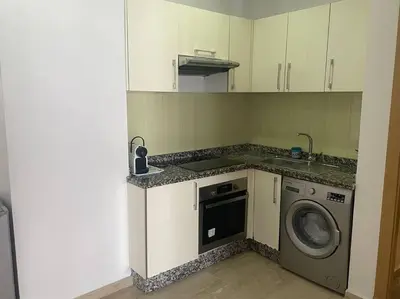 a kitchen with a washing machine and a washer at Studio La gironde in Casablanca