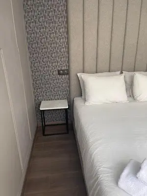 a bedroom with a bed and a side table at Magic Appartement Luxury Gauthier 10 in Casablanca