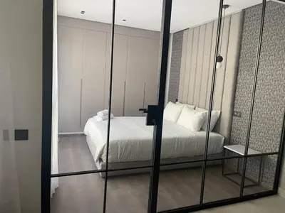 a bedroom with a bed and a mirror at Magic Appartement Luxury Gauthier 10 in Casablanca