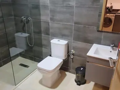 a bathroom with a toilet and a shower and a sink at Appartement Parc Mohammedia in Mohammedia
