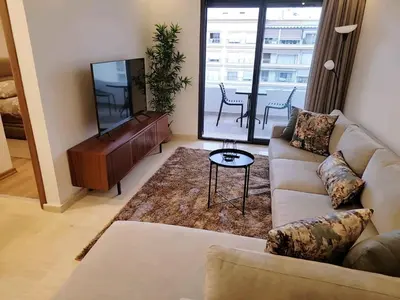 a living room with a couch and a piano at Appartement Parc Mohammedia in Mohammedia
