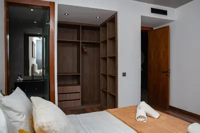 a bedroom with a bed with wooden shelves at Appartement neuf 2 chambres avec salle de sport in Casablanca