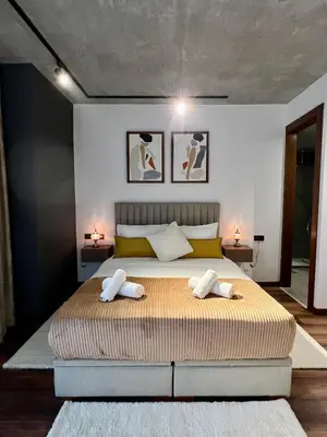a bedroom with a large bed with two towels at Appartement neuf 2 chambres avec salle de sport in Casablanca