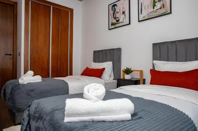 two beds with towels on them in a bedroom at Appartement neuf 2 chambres avec salle de sport in Casablanca