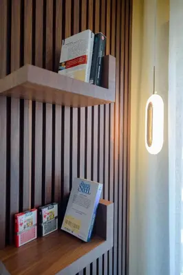 a book shelf with books on top of it at Appartement luxueux et lumineux Maarif Casablanca in Casablanca