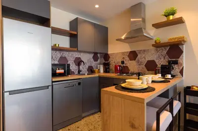 a kitchen with stainless steel appliances and a counter at Appartement luxueux et lumineux Maarif Casablanca in Casablanca