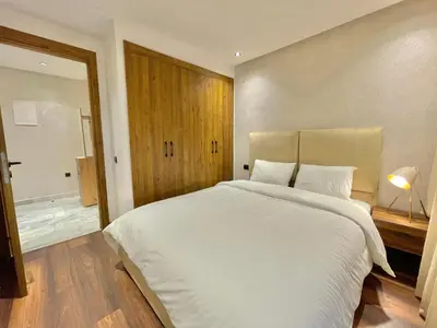 a bedroom with a large white bed and a window at D1115 Studio au Cœur de Casablanca Proximité et Confort1 in Casablanca
