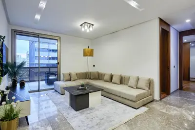 a living room with a couch and a table at Modern Unit in Casa Finance City With Free Parking in Casablanca