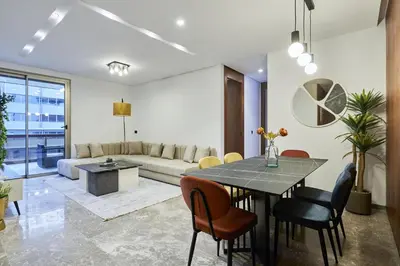 a living room with a table and chairs at Modern Unit in Casa Finance City With Free Parking in Casablanca