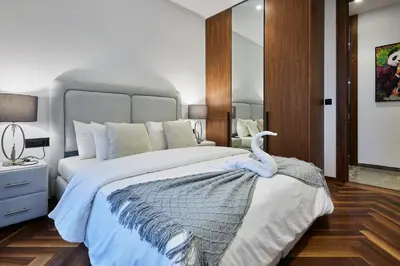 a bedroom with a large bed with a swan on it at Modern Unit in Casa Finance City With Free Parking in Casablanca