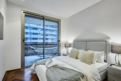 a bedroom with a large bed and a large window at Modern Unit in Casa Finance City With Free Parking in Casablanca